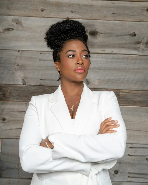 a woman wearing a white suit posing for the camera