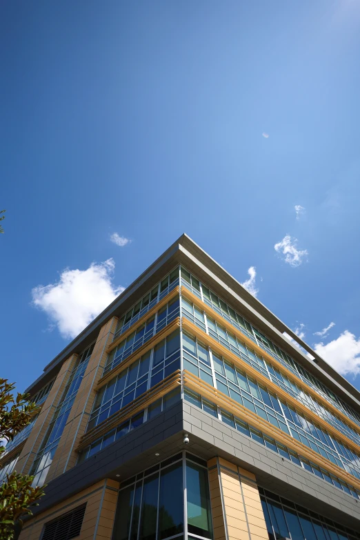 a building with lots of windows sits under a blue sky