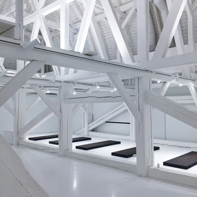 a room with white panels and wooden structures