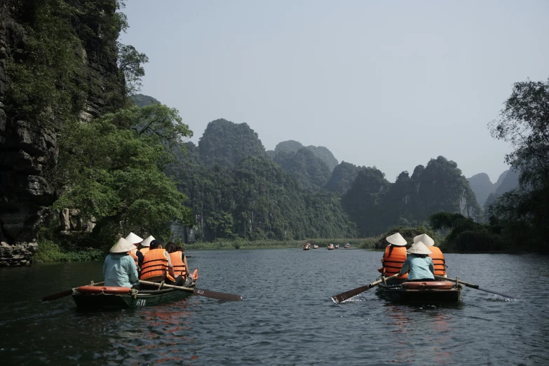 people in boats in the middle of a body of water