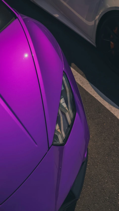 an image of the front end of a purple sports car