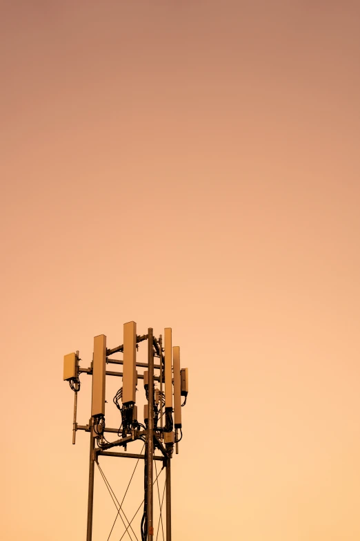 a cellular phone tower sits near the sun