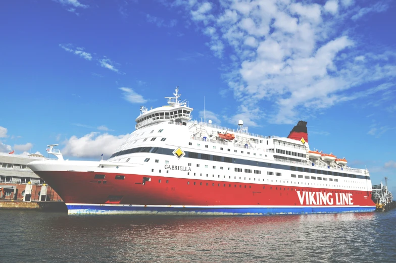 the large red and white cruise ship is in the port