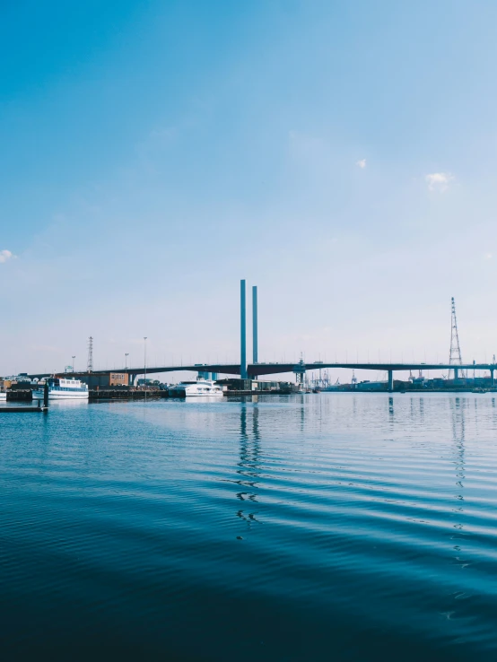 a view from the ocean looking at boats and an industrial area