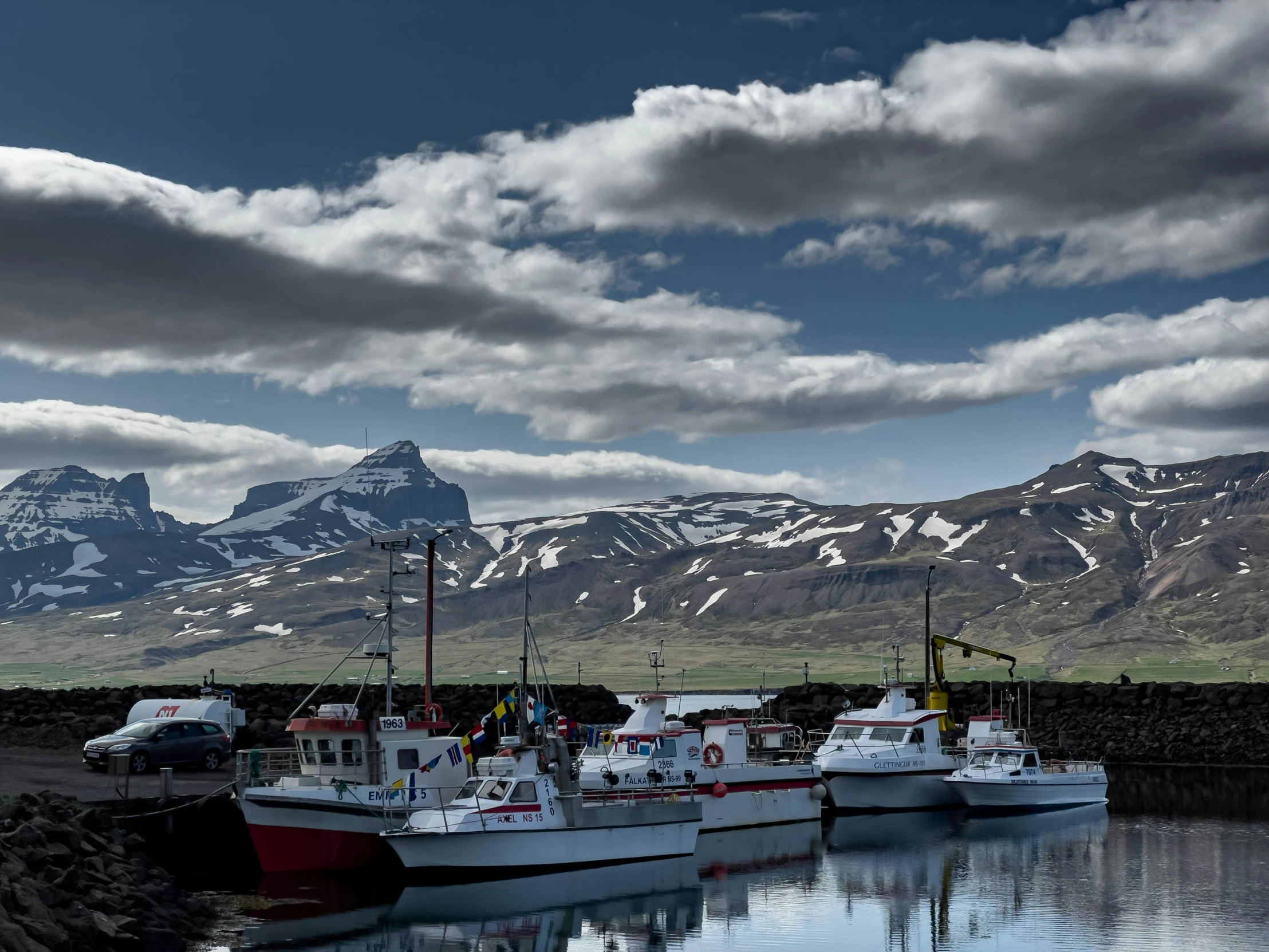 several boats sitting at the dock in the water