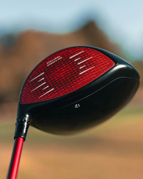 an electronic golf driver in red showing the number ten