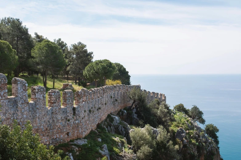 a bridge spanning over a steep cliff near the ocean