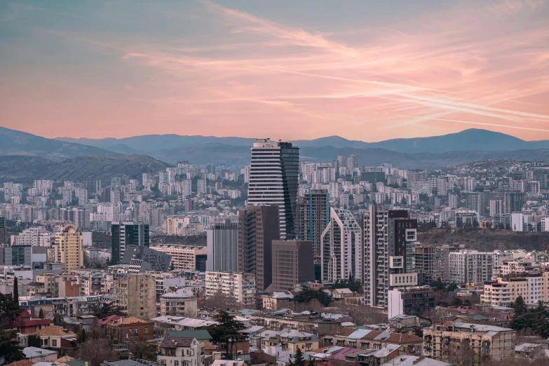 a view of a city skyline with the mountains in the distance