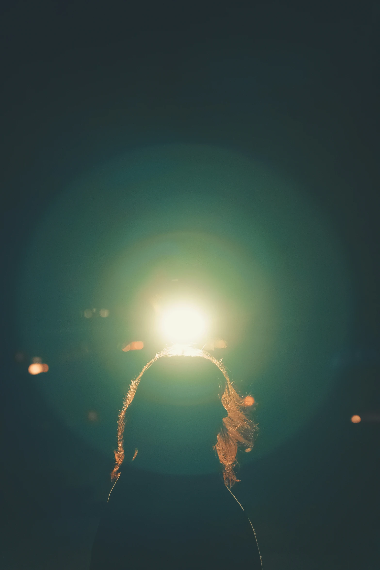 a person standing on the beach holding a light