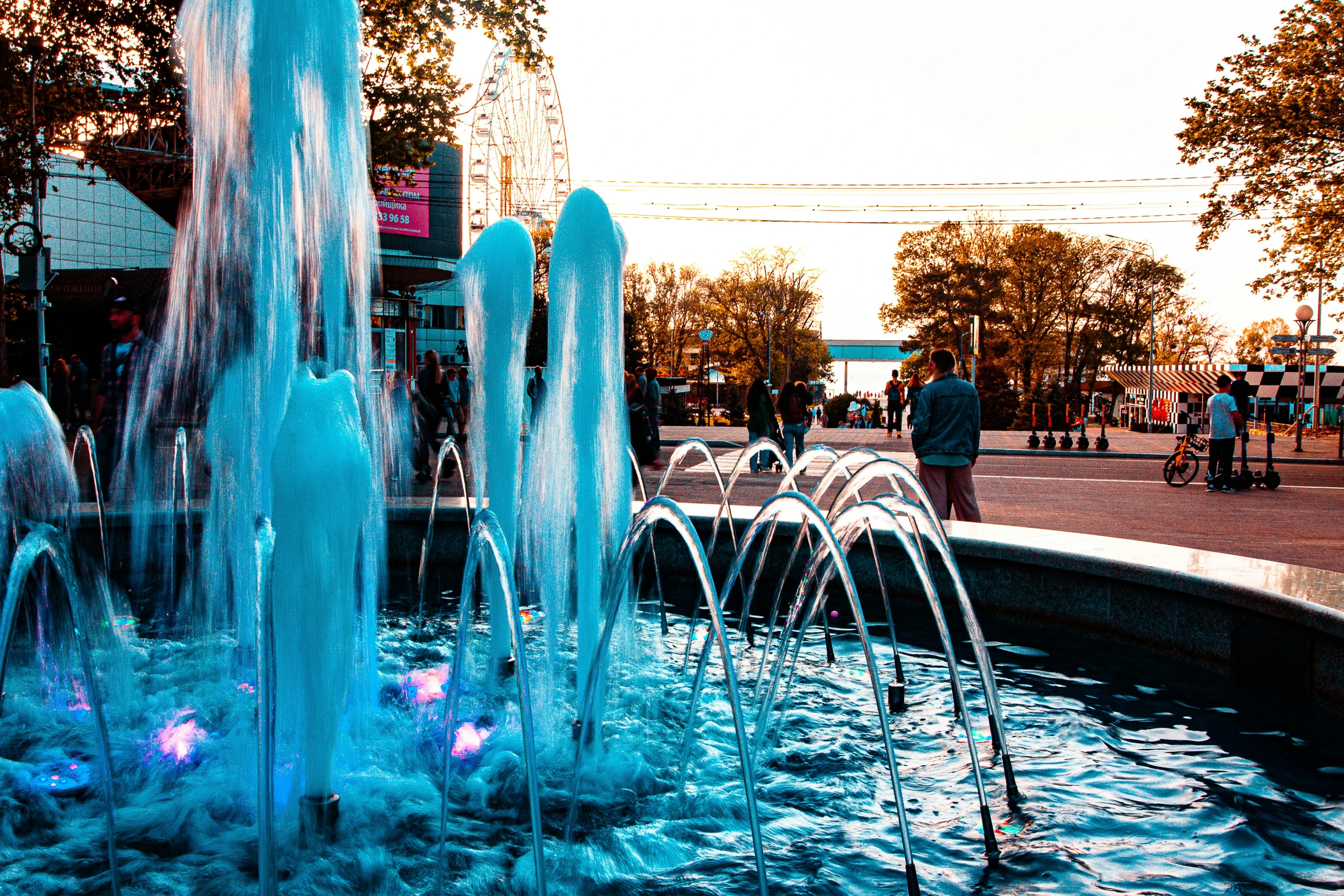 a water fountain with people standing around