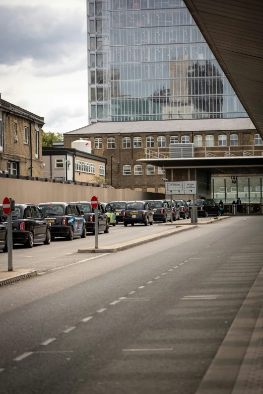 cars parked on both sides of the street in front of a building