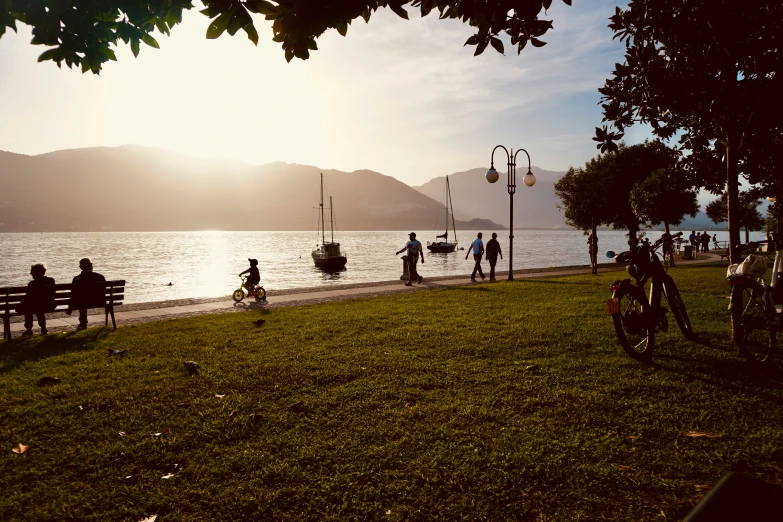 people walking near the water on a bright day