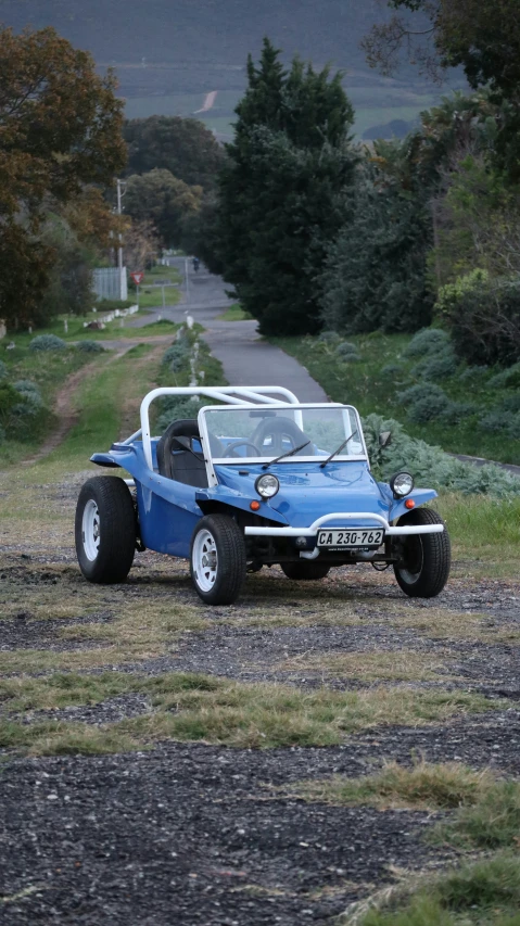 an old model buggy on the side of a road