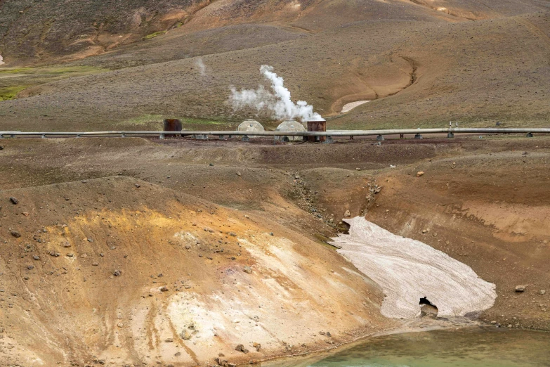 an abandoned train engine, in the middle of a valley