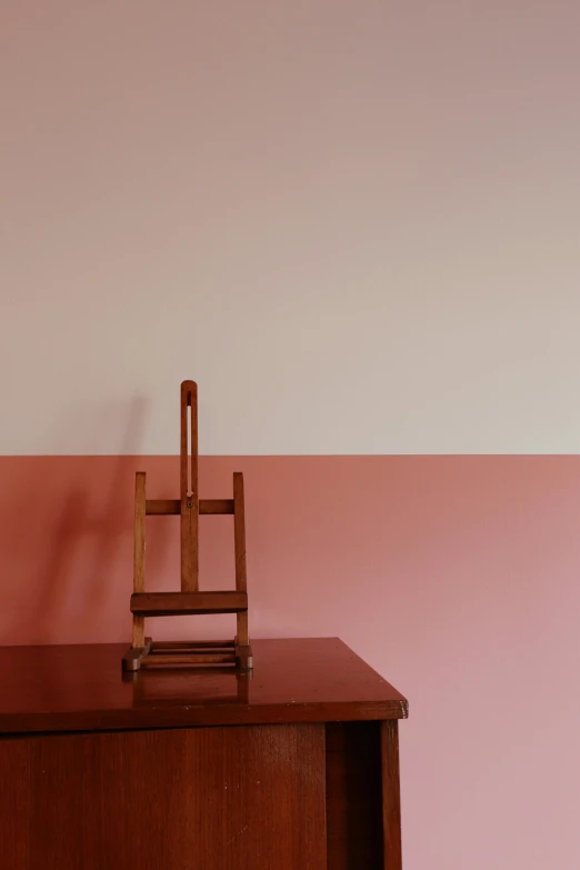 a small wooden chair on top of a table