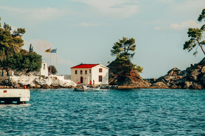 a red and white house on a small island