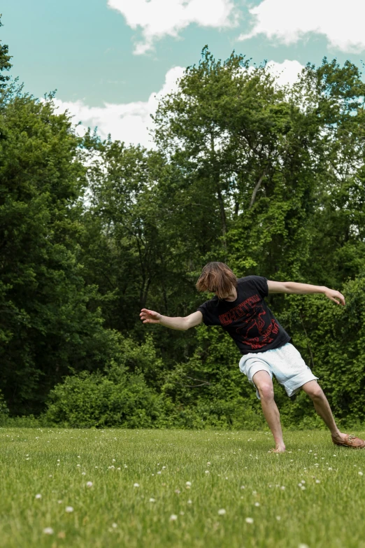 young man doing kick up during frisbee game