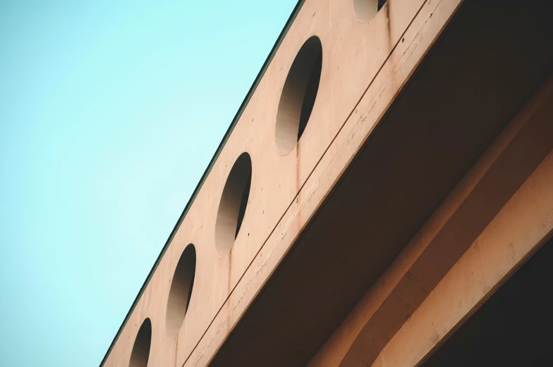 a brick building with holes at the top and small windows on each side