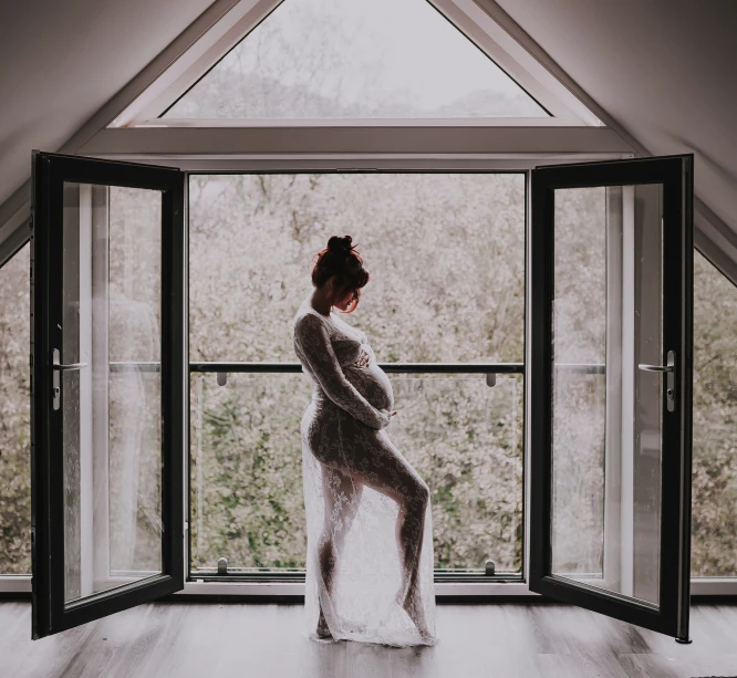 woman in white gown standing on wooden floor