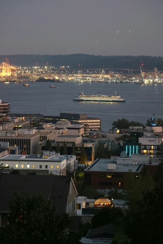 some lights that are on the water in the evening