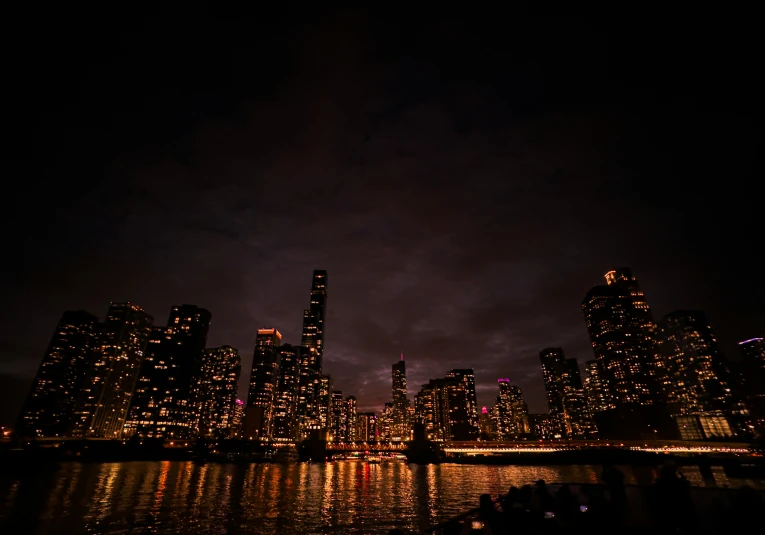 the dark city is shining brightly at night