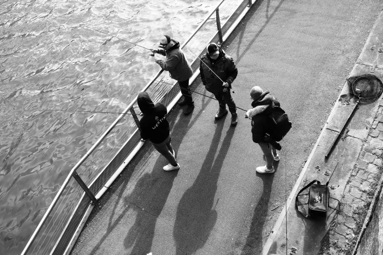 a couple of people that are standing near the water