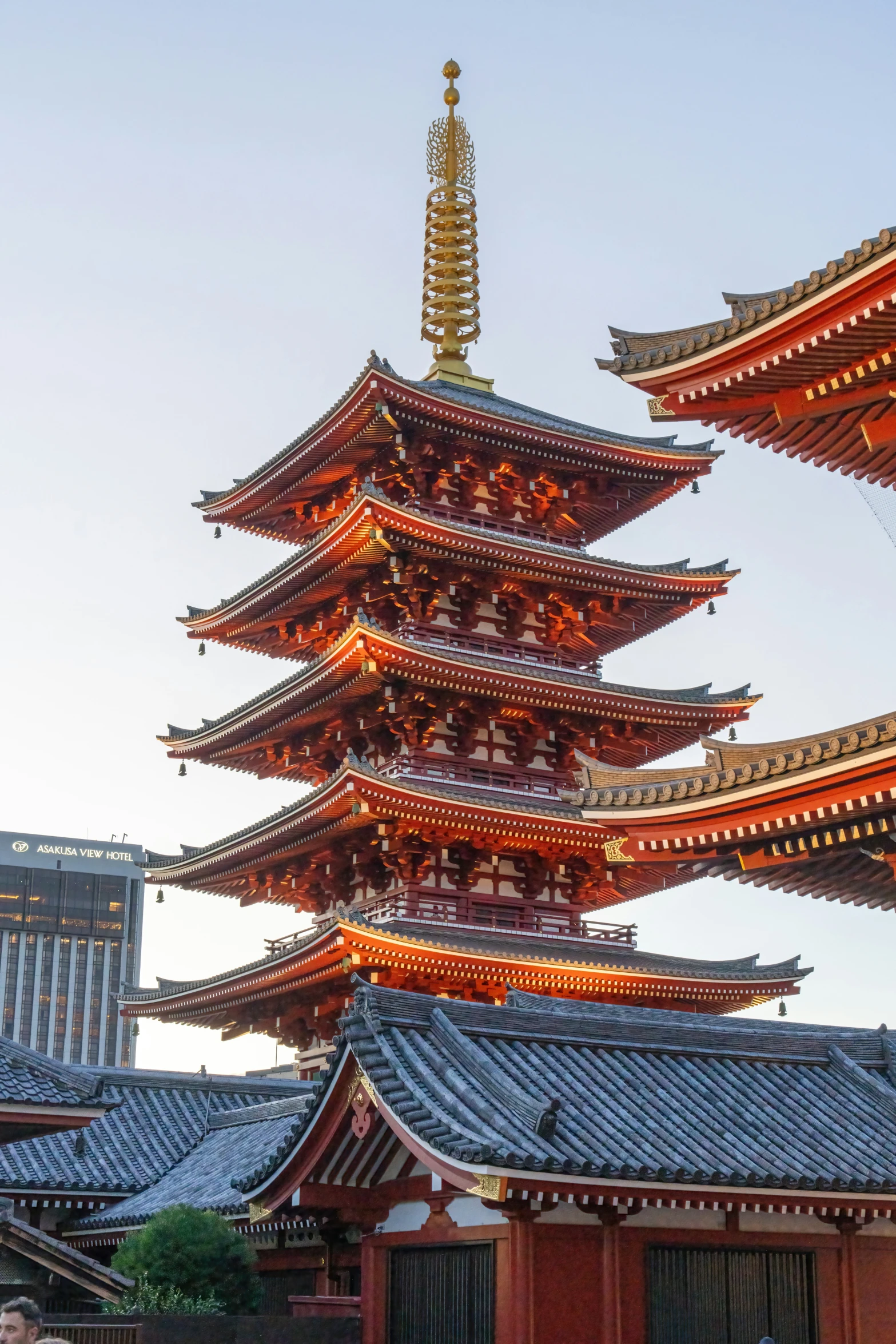 an asian building with a tall tower next to buildings