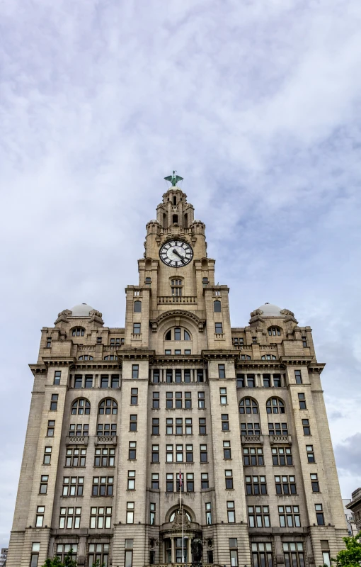 an old and large building with clocks on the top