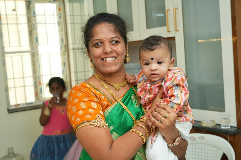 a woman with a baby holding it in her arms