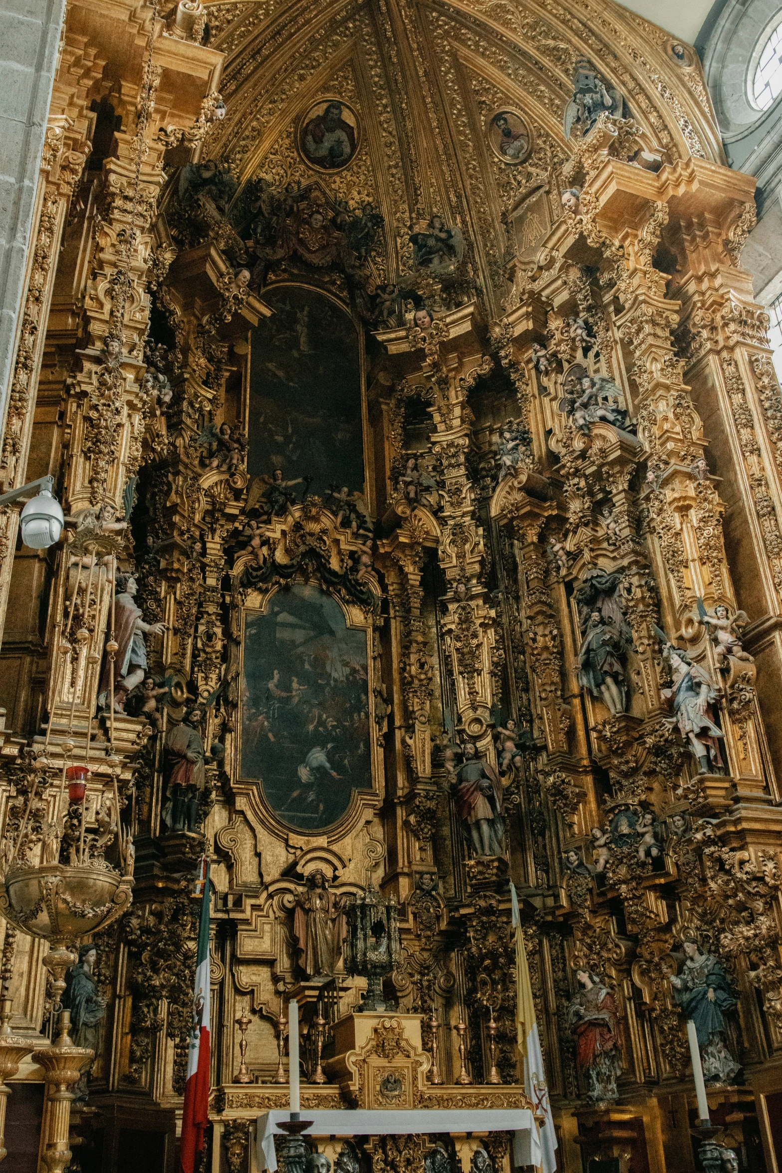 an intricately decorated church has ornately colored wooden pillars and pillars