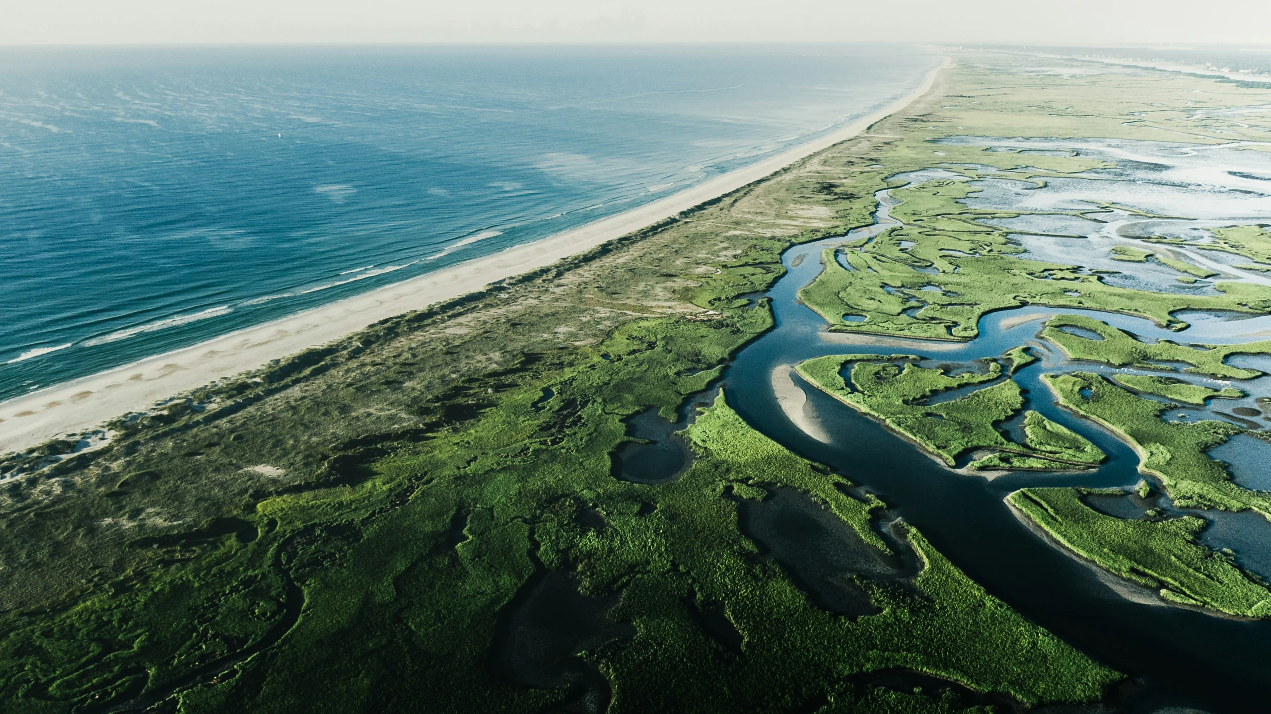 an aerial view of the ocean near the shore