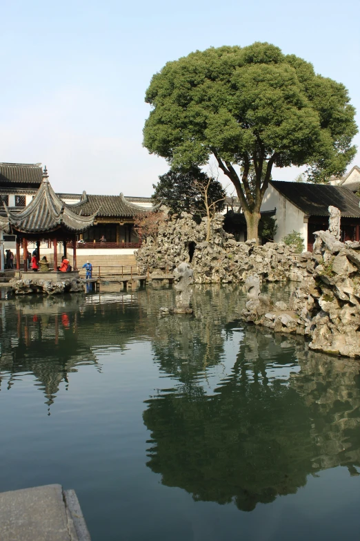 an old chinese building with some trees next to it