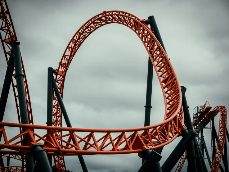 a tall orange roller coaster that looks like an apple