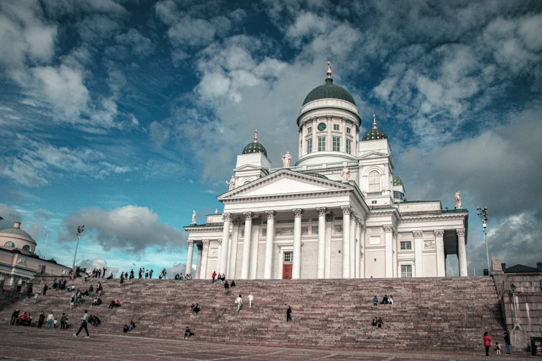 a large white building with stairs up to it's top