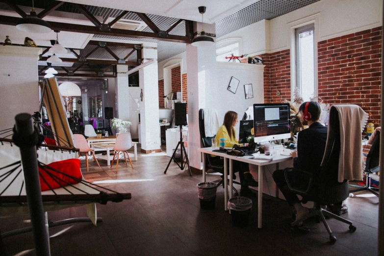 an office space with two people sitting at computers