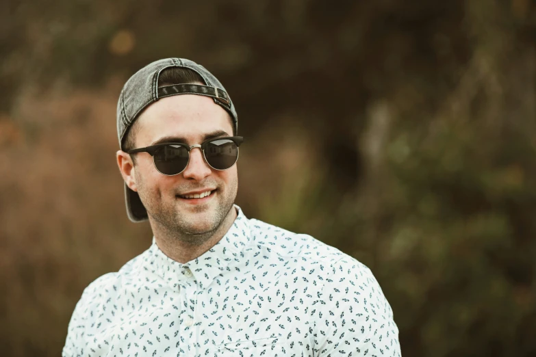 a man with sunglasses and cap wearing a baseball hat