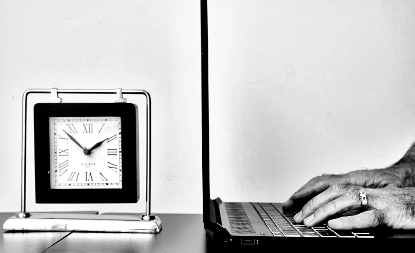 a person working on a laptop while typing on the keyboard