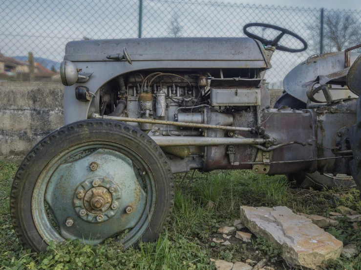 an old, rusty, abandoned tractor is shown