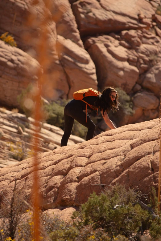 a woman climbing a rock into the air