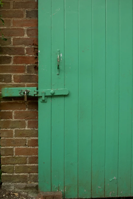 a large green door with an iron handle