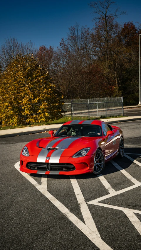 a red sports car is parked in the lot