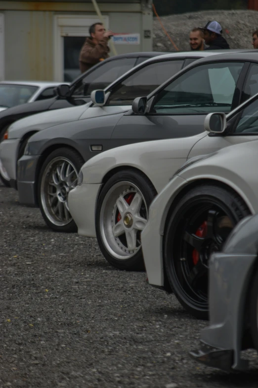 a row of different colored cars parked next to each other