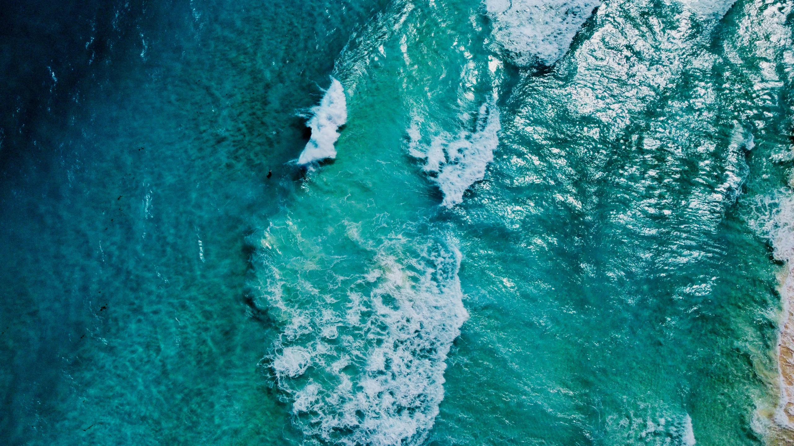 some waves on water and rocks in the ocean