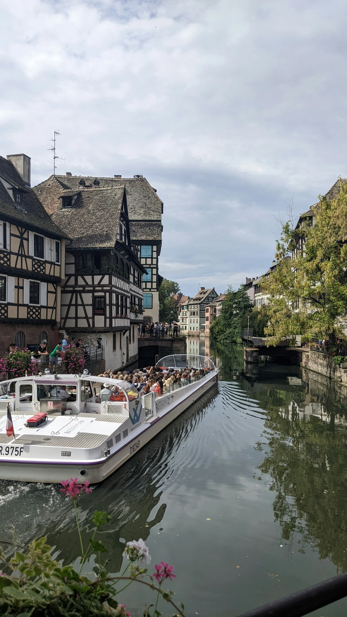 a boat in the water passing by old buildings