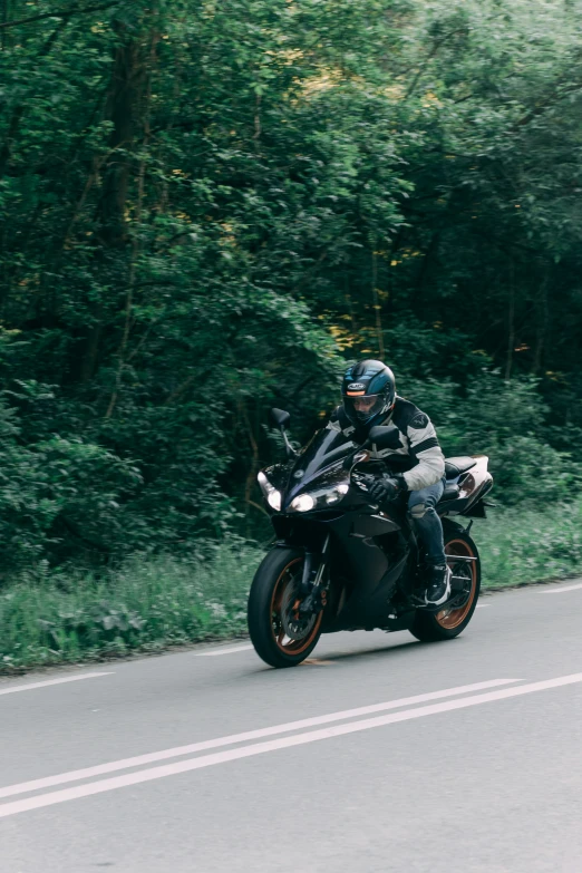 a man is riding a motorcycle along a road