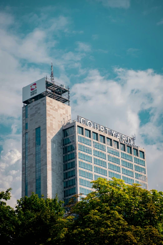 a tall building with chinese writing on the top of it