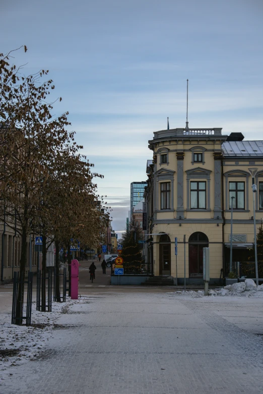 an old building and some trees in the snow