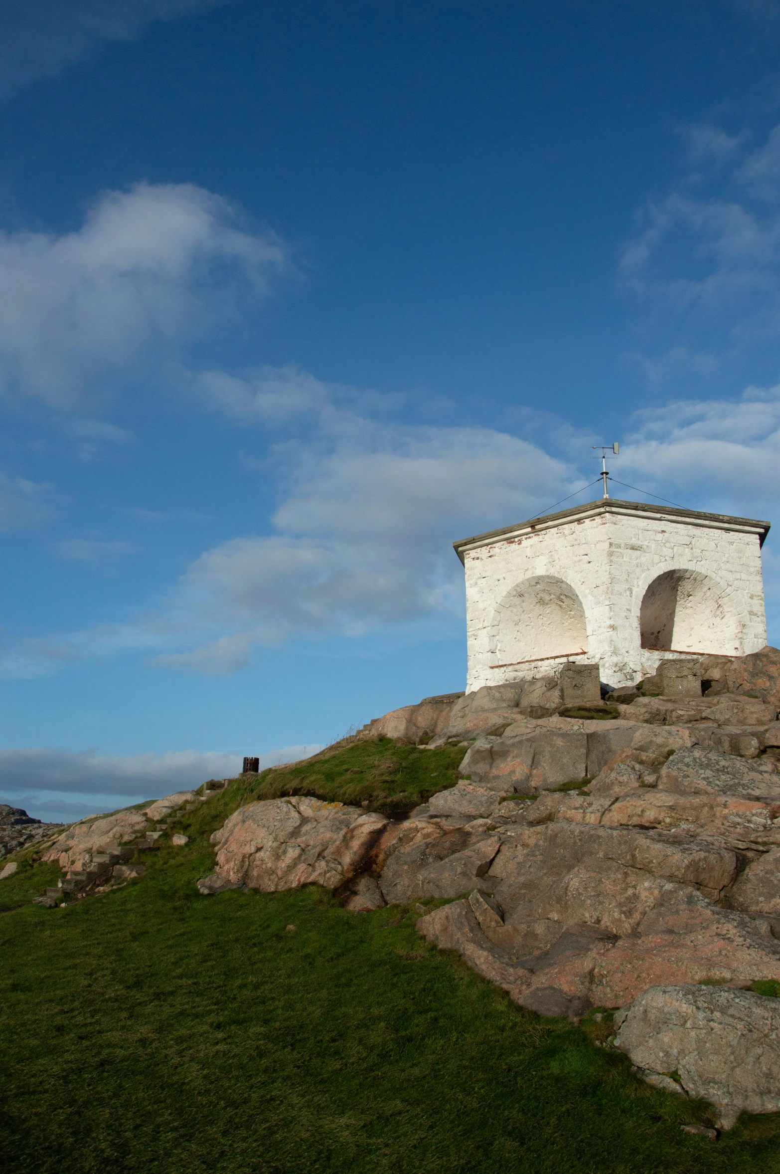 a rock tower perched high up on a mountain