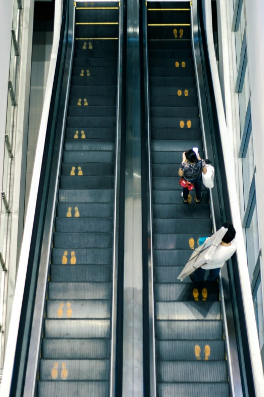 a person riding an escalator at a mall