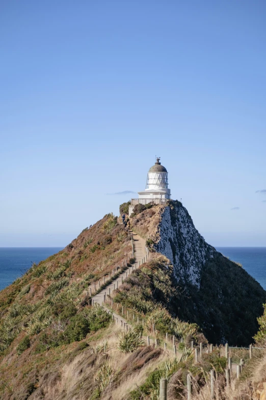 a hill that has a light tower on it